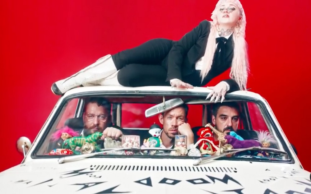 Hiatus Kaiyote packs into a tiny white car in the video for their new single "Red Room"